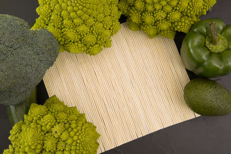 Healthy vegetarian food, fresh green food romanesco broccoli, pepper, zucchini and avocado (Green)の写真素材