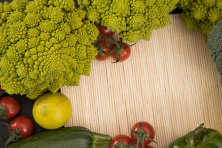 fresh vegetable, romanesco broccoli, pepper, zucchini, avocado, lemon and cherry tomato, free space in your text.の写真素材