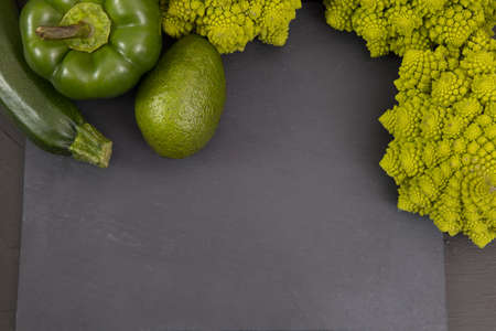 fresh green food, green vegetable, romanesco broccoli, pepper, avocado, on a stone plate, free space in your text.の写真素材