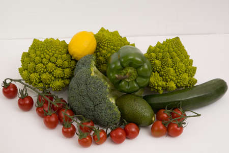 fresh vegetable, romanesco, pepper, zucchini, avocado, cherry tomato and lemon free space in your text, on a isolated background.の写真素材