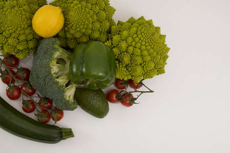 fresh vegetable, romanesco, pepper, zucchini, avocado, cherry tomato and lemon free space in your text, on a isolated background.の写真素材