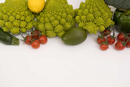 fresh vegetable, romanesco, pepper, zucchini, avocado, cherry tomato and lemon free space in your text, on a isolated background.の写真素材