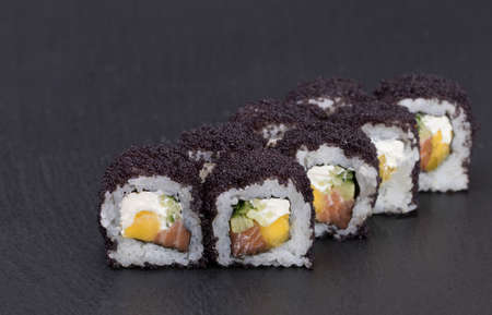 Sushi Rolls Tokyo Night Roll with RICE, SALMON, MANGO, CREAM CHEESE, CUCUMBER and MASAGO.の写真素材