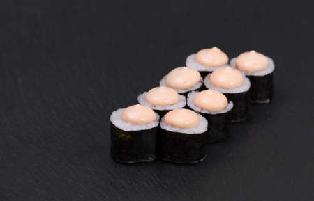 Sushi Rolls Spicy Sake Maki with Rice, LASIS, and hot Sriracha sauce.の写真素材