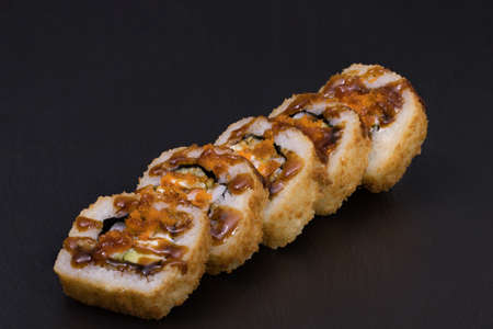 Sushi Rolls Ebi Tempura Maki with RICE, TIGER SHRIMPS, CREAM CHEESE, AVOCADO, CUCUMBER, MASAGO and TERIJAKI sauce.の写真素材