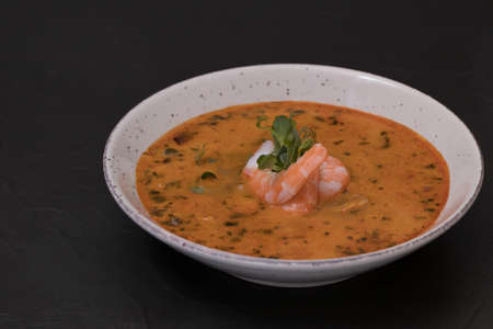 Hot soup with Coconut nut milk, Tom Yum pasta, mushrooms, tiger prawns and chicken filletの写真素材
