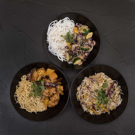 Wok set, salad on a black background.の写真素材