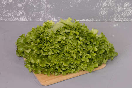 Raw organic green on a wooden desk and gray background.の写真素材