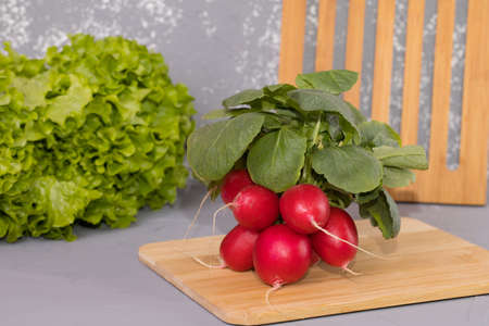 Radishes, on brown wooden desk and gray background.の写真素材