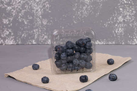 Fresh blueberry on rustic fabric, a gray background.の写真素材