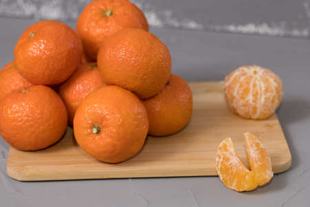 Fresh mandarin oranges fruit or tangerines on wooden deskの写真素材