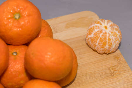 Fresh mandarin oranges fruit or tangerines on wooden deskの写真素材