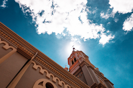 Church against the sky with clouds view from belowの写真素材