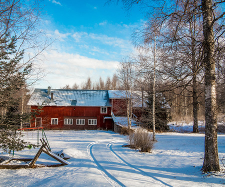 Old stable in a wood in winter clear day in Finland.のeditorial素材