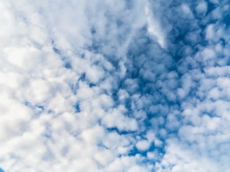 Soft white clouds against blue skyの写真素材