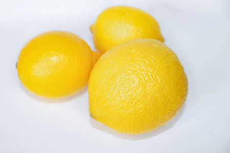 three lemons on a white backgroundの写真素材