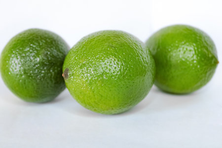 three limes on a white backgroundの写真素材