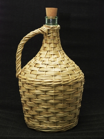 Braided empty bottle on a dark backgroundの写真素材