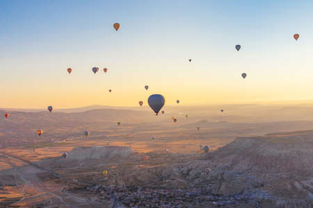 Balloons on the background of the valley in the morning haze. Amazing Cappadocia, Turkey.の写真素材