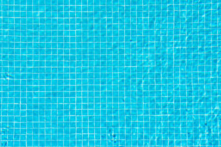 Calm blue water in the pool. You can clearly see the squares from the tiles at the bottom. Copy space.の写真素材