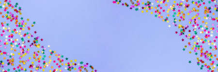 Web banner with multicolored stars on paper background in color 2022 Very Peri. Festive background. Copy-space.の写真素材