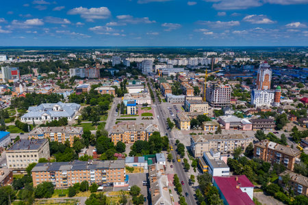 Beautiful summer top view of the city. Roofs of houses, roads, cars, trees with green leaves.の写真素材
