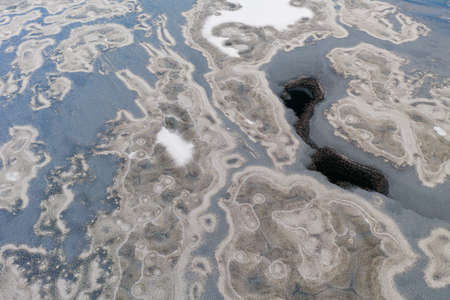 Top view of frozen ice on the river. River in ice. Beautiful snow and frost on the ice.
