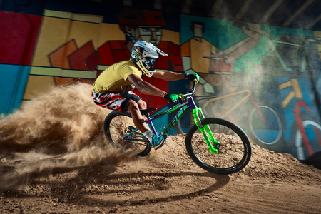 Moscow, Russia - August 8, 2017: Biker riding with aggressive turns. Mountain Bike cyclist riding pump track. Rider in action at mountain bike sport. Cool athlete cyclist on a bike. MTB biking.のeditorial素材