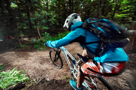Moscow, Russia - August 18, 2017: Jump and fly on a mountain bike. Rider in action at mountain bike sport. Biker riding in forest. Cool athlete cyclist on a bike. Close up.のeditorial素材