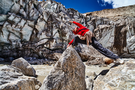 The man practice yoga pose in mountains (Himalaya). Gangotri, India.のeditorial素材