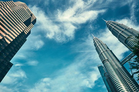 Kuala Lumpur, Malaysia - November 20, 2017. Petronas Twin Towers. Skyscrapers view from street level, with blue sky on background. Image with place for textのeditorial素材
