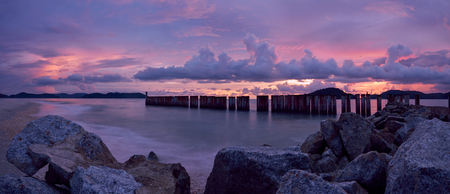 Sunset over beach with pink colours. Panorama. Pantani Cenang and Pantani Tengah beachs, Langkawi, Malaisiya.の写真素材
