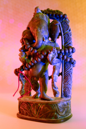 Hindu God - Lord Ganesha with rudraksha rosary in a colorful light. Colorful photo of deity Ganesha whit blured background.の写真素材
