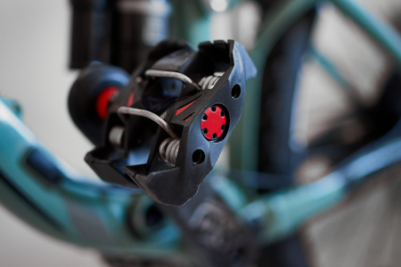 Bicycle clipless pedal.  Blurred image.