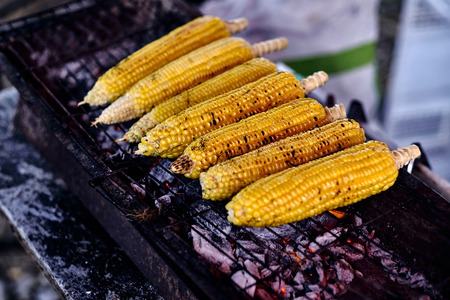 Corn cobs on the grill. Close up image with corns. Asian, Indian and Chinese street food. Food court on local market of Langkawi island, Malaysia.の写真素材