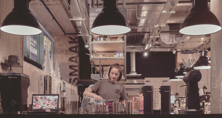 Moscow, Russia - Jan 2019: Lady barista steaming milk at the urban coffee shop.のeditorial素材