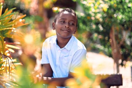 Kuala Lumpur, Malaysia - Jul, 2019: Closeup portrait of smiling young attractive African boy in park.のeditorial素材