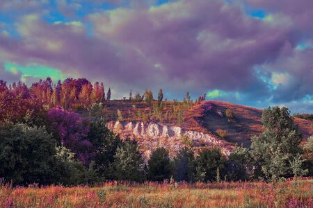 Ð oetic rural landscape with grass, dramatic sky and puffy clouds. Impressionist style color grading. Russia, Samara.の写真素材