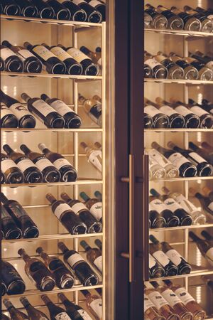 Moscow, Russia - Dec 2019: Mood shot of grand red and white wines in rack in restaurant.