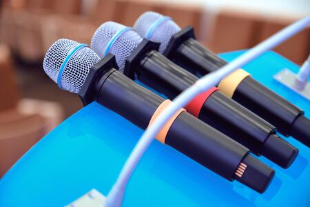 Wireless microphones on the table. Close up of microphones in conference room. Closeup at business conference.の写真素材