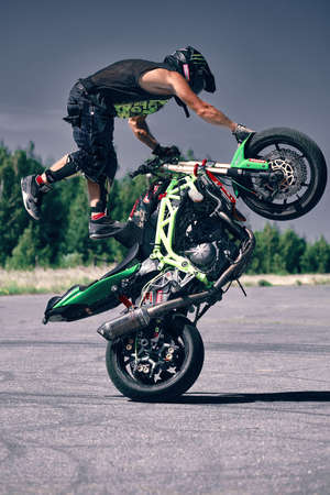 Moscow, Russia - Jul 12, 2020: Moto rider making a stunt on his motorbike. Stunt motorcycle rider performing motorcycle show.のeditorial素材