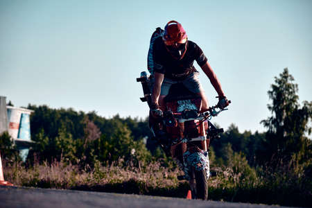Moscow, Russia - Jul 12, 2020: Moto rider making a stunt on his motorbike. Stunt motorcycle rider performing motorcycle show. Motorcyclist making doing a difficult and dangerous stunt on his motorbikeのeditorial素材