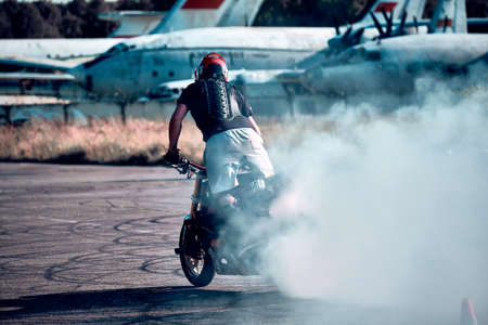 Moscow, Russia - Jul 13, 2020: Moto rider making a wheels burn on his motorbike. Stunt motorcycle rider performing motorcycle show. Motorcyclist making doing dangerous stunt on motorbikeのeditorial素材