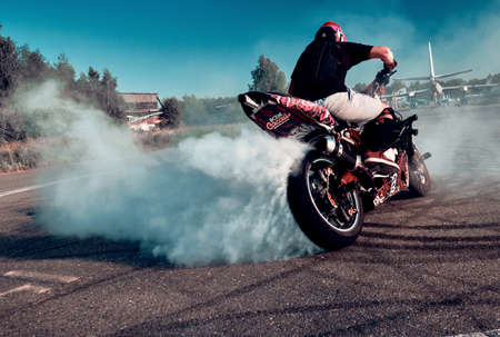 Moscow, Russia - Jul 13, 2020: Moto rider making a wheels burn on his motorbike. Stunt motorcycle rider performing motorcycle show. Motorcyclist making doing dangerous stunt on motorbikeのeditorial素材