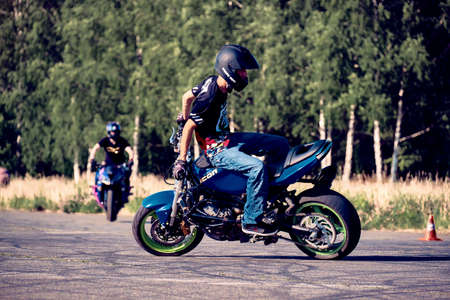 Moscow, Russia - Jul 12, 2020: Moto rider making a stunt on his motorbike. Stunt motorcycle rider...