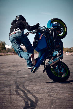 Moscow, Russia - Jul 12, 2020: Moto rider making a stunt on his motorbike. Motorcyclist making wheelie a difficult and dangerous stunt on his motorbikeのeditorial素材