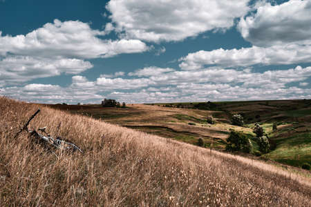Mountain bike in wild nature landscape background. Panoramic landscape of central Russia agricultural countryside with hillの写真素材