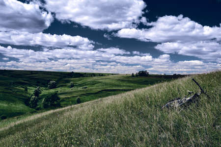 Mountain bike in wild nature landscape background. Panoramic landscape of central Russia agricultural countryside with hillの写真素材