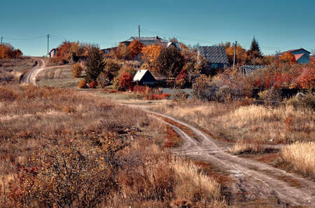 A country road to village. Autumn sunny day. Countryside landscape of central Russia. Vintage color...