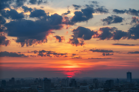 Panoramic shot of cityscape view megalopolis after sunset with beautiful cloudsの写真素材